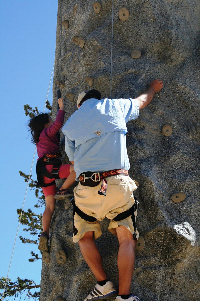 People climbing outdoor climbing wall