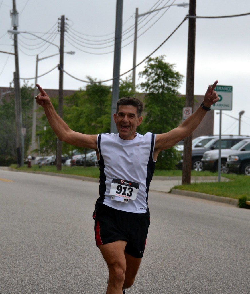 Race runner celebrating, no compression gear visible