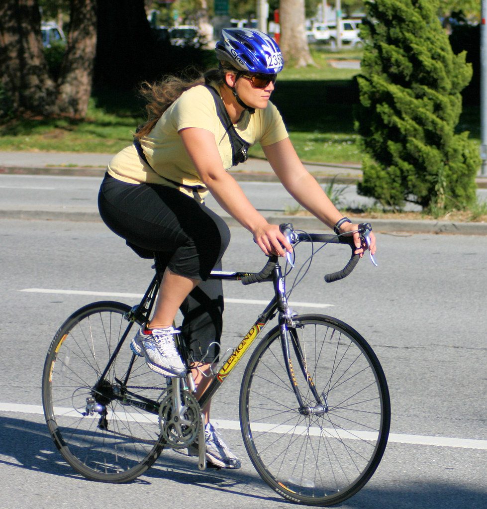 Casual cyclist on road bike in street