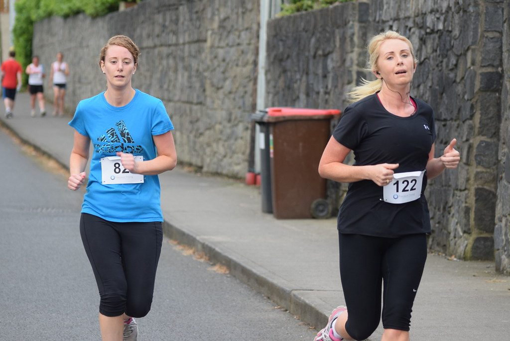Two women running in road race