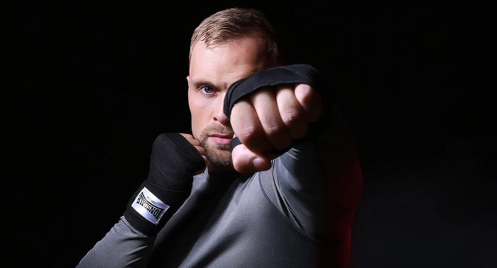 Man in hand wraps posing in boxing stance