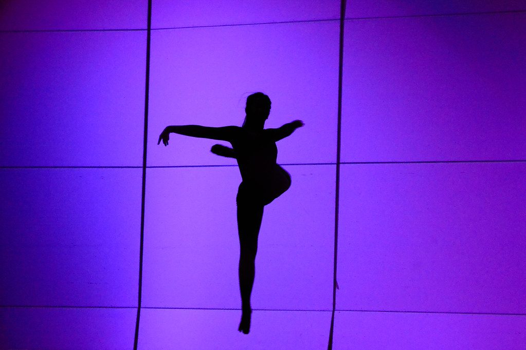 Dancer silhouette against purple backdrop