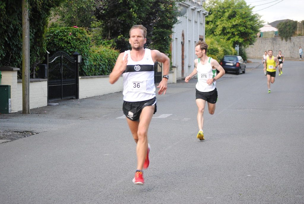 Road race runners on village street