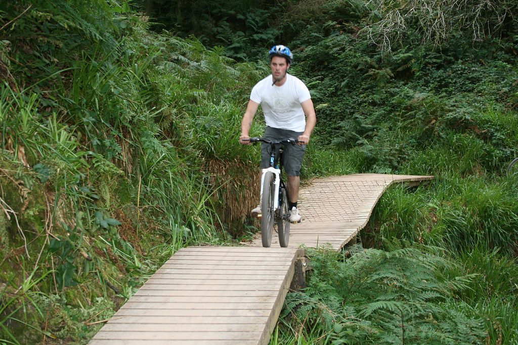 Casual rider on wooden boardwalk trail