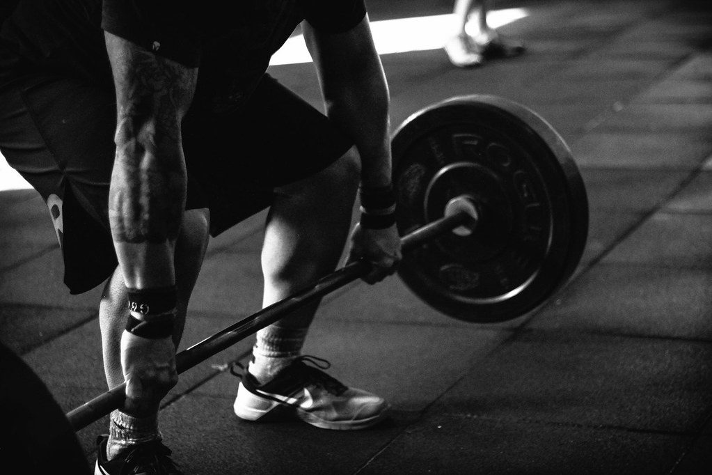 B&W lifter gripping loaded barbell