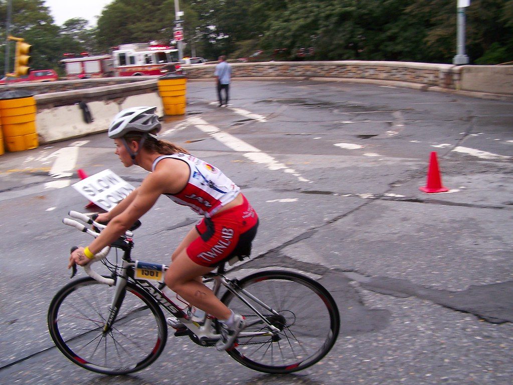 Triathlete cycling on road course