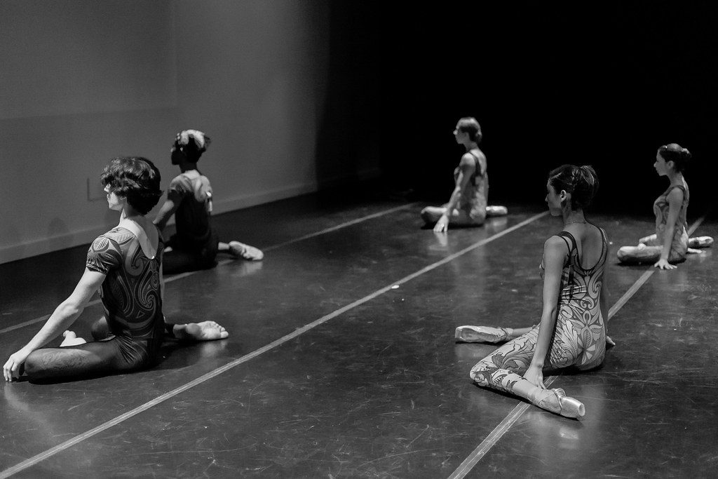 B&W dancers stretching on studio floor