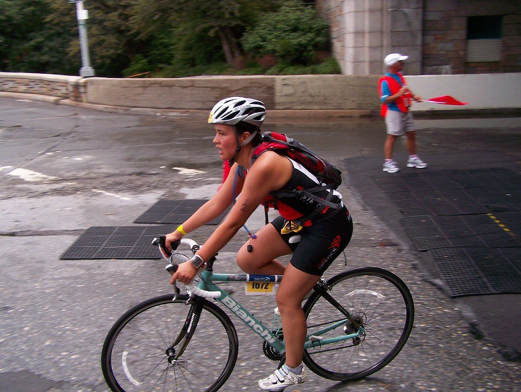 Triathlete cycling on wet race course