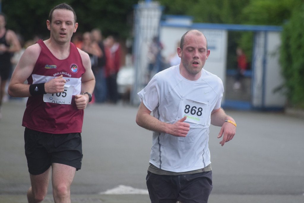 Two runners racing on road