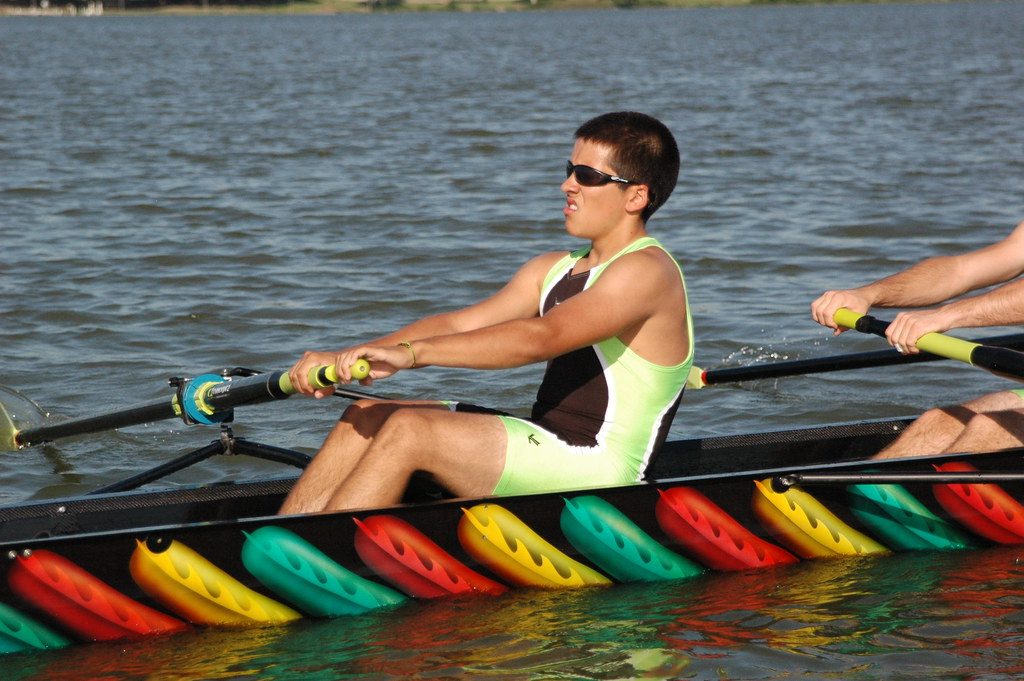 Rower in sculling boat on water
