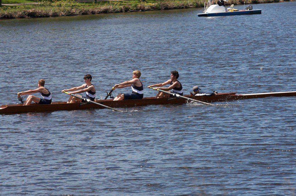 Rowing crew sculling on water