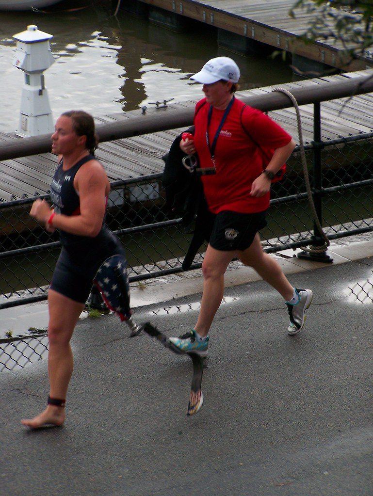 Triathletes running along waterfront