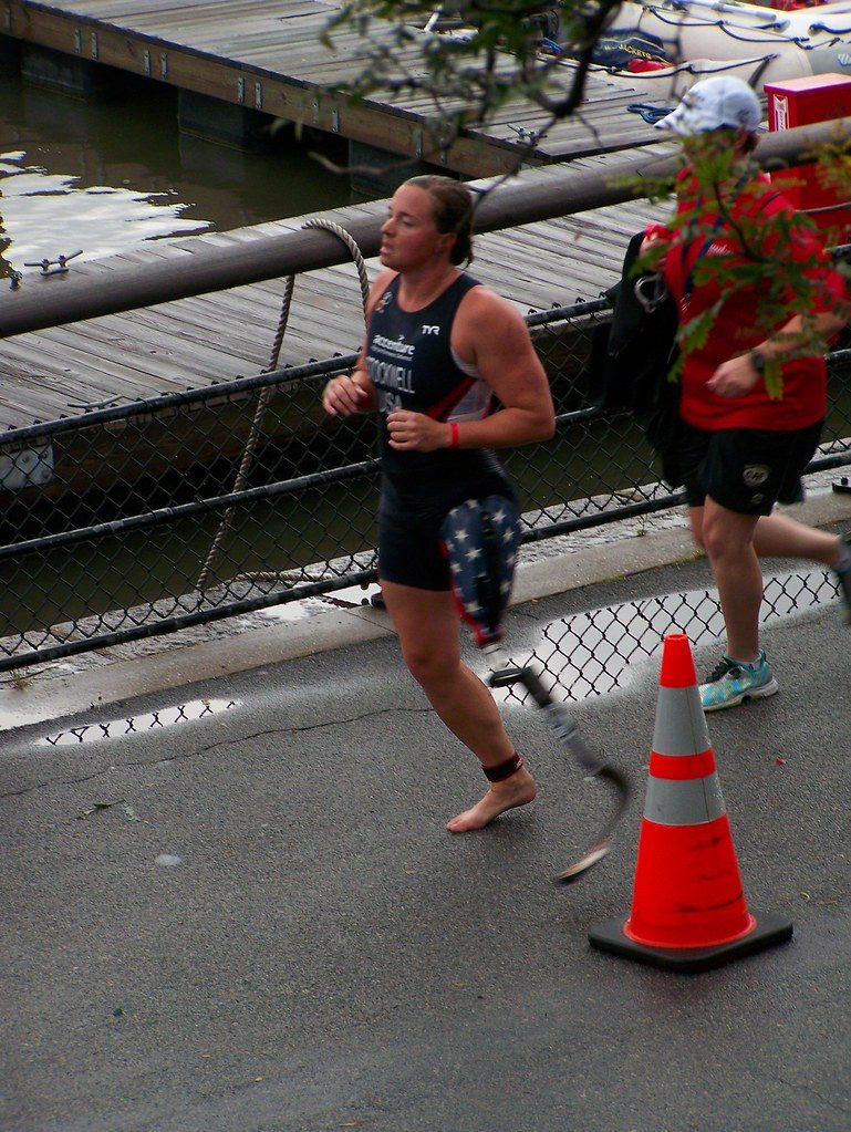 Triathletes running along waterfront