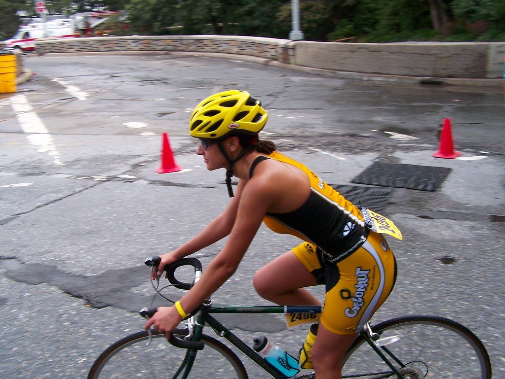Triathlete cycling on road; bike not run