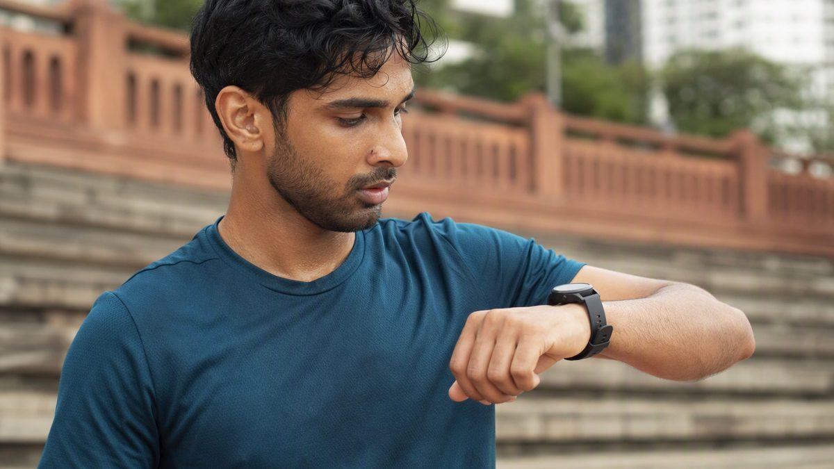 Athlete with smartwatch showing HRV and strain data