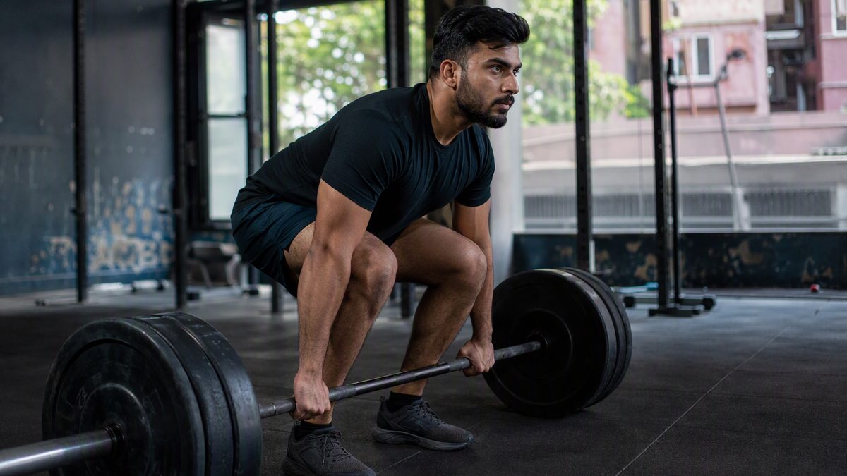 Lifter performing barbell squat or deadlift