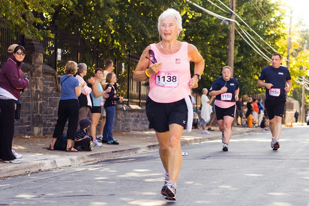 Older woman running in road race
