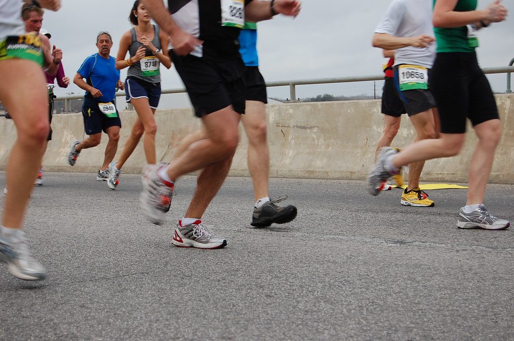 Marathon runners' legs on road